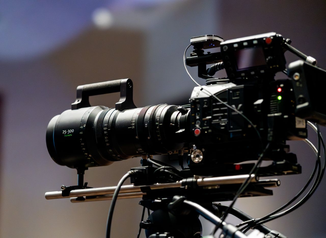 Close-up of a professional film camera with lens setup, perfect for video production imagery.